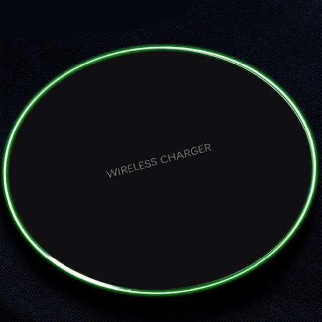 Wireless charger with green border on a black background