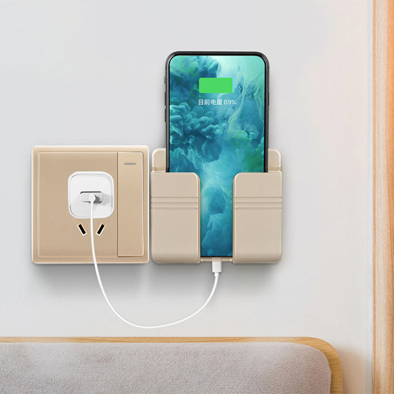 Champagne gold phone holder with smartphone and power adapter on a light gray background
