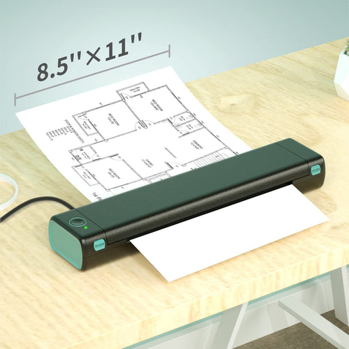 A desktop document printer on a light wood desk, feeding a sheet of architectural floor plan paper.