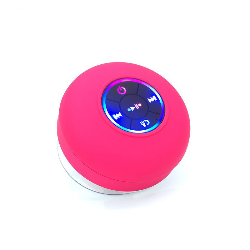 Pink spherical Bluetooth speaker with control buttons on a white background