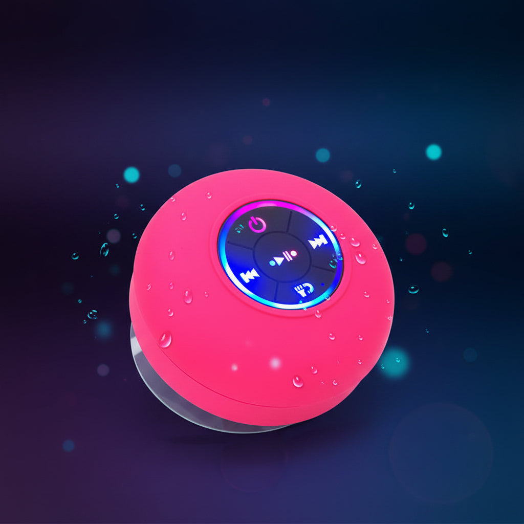 Pink spherical device with a glowing blue light on a dark background