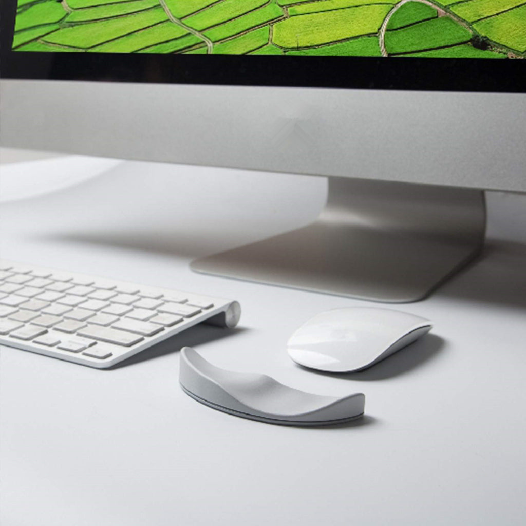 Ergonomic gliding silicone wrist rest placed next to a computer mouse on a clean desk setup