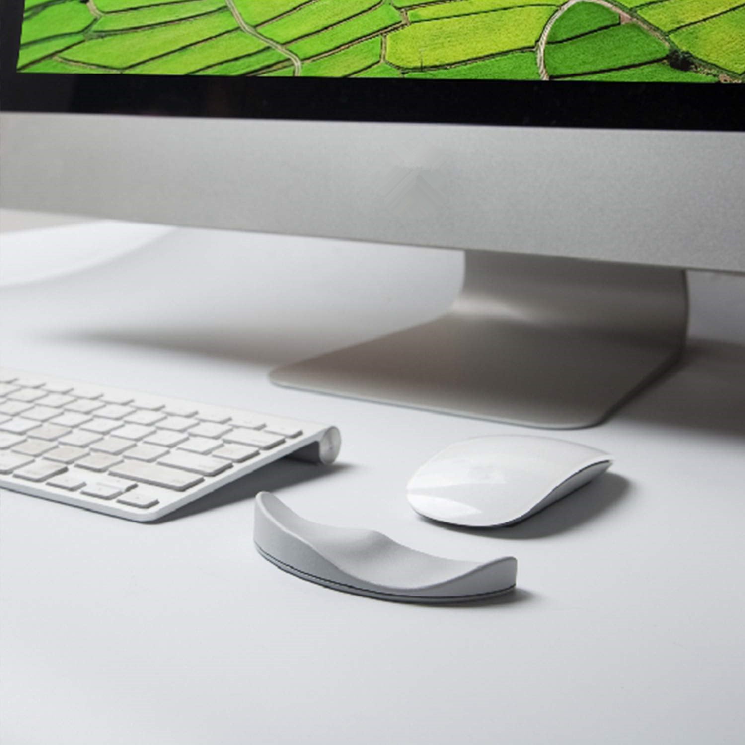 Ergonomic gliding silicone wrist rest placed next to a computer mouse on a clean desk setup