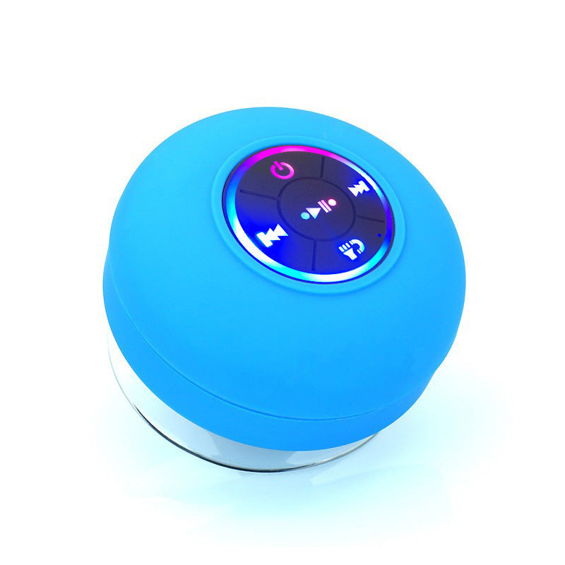 Blue round Bluetooth speaker with control buttons on a white background