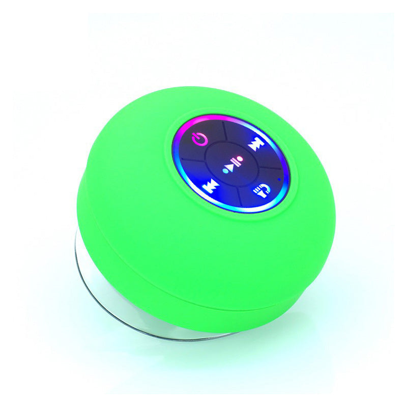 Green spherical Bluetooth speaker with control buttons on a white background