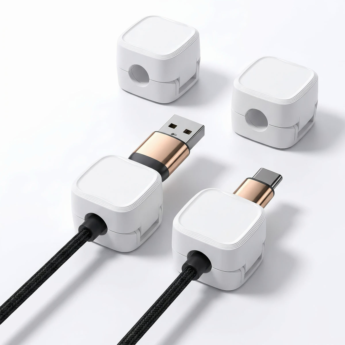 Four white magnetic cable management clips showing two attached to USB A and USB C braided cables
